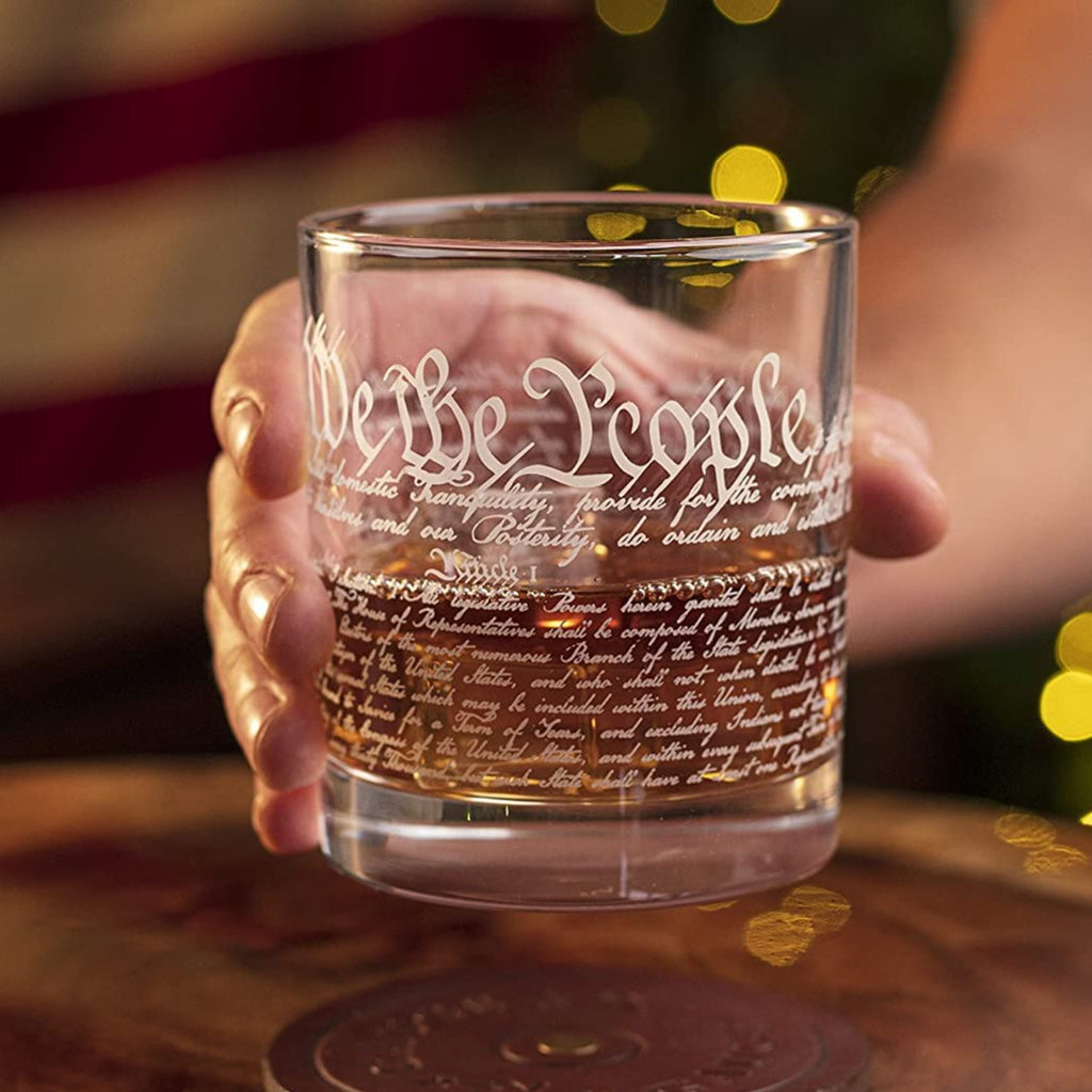 Holding We The People Whiskey Glass